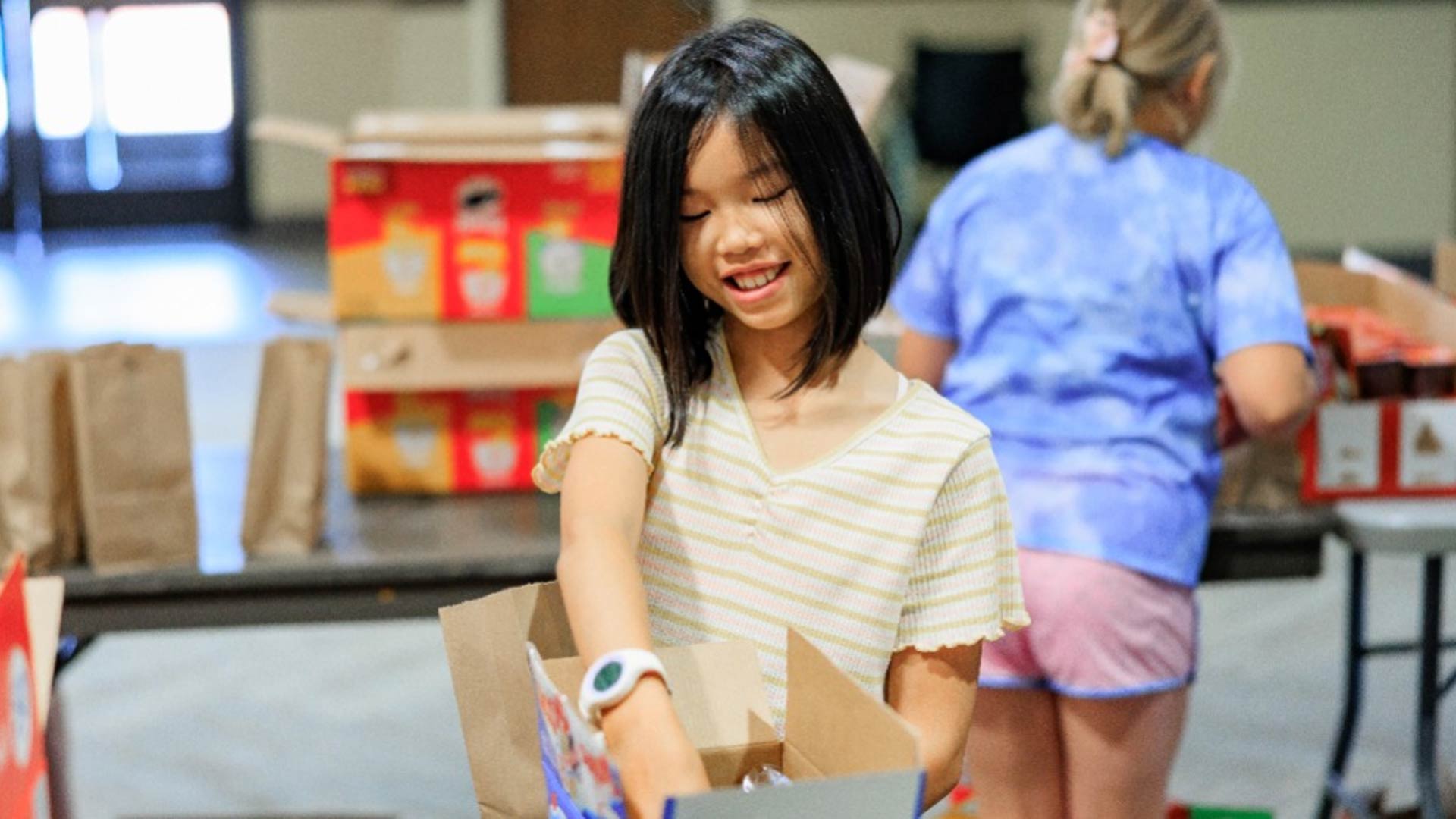 Volunteers packing summer lunches for those in need