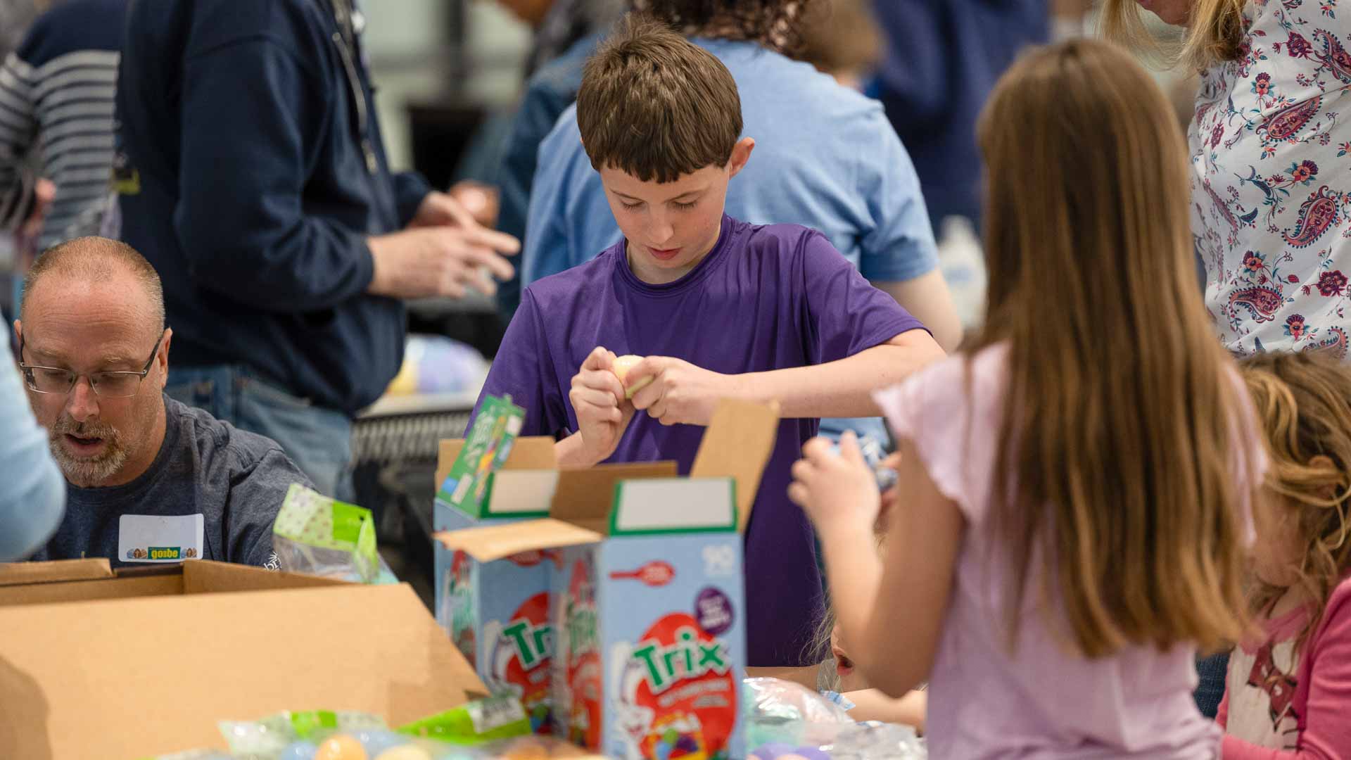 Go and Be volunteers packing Easter eggs