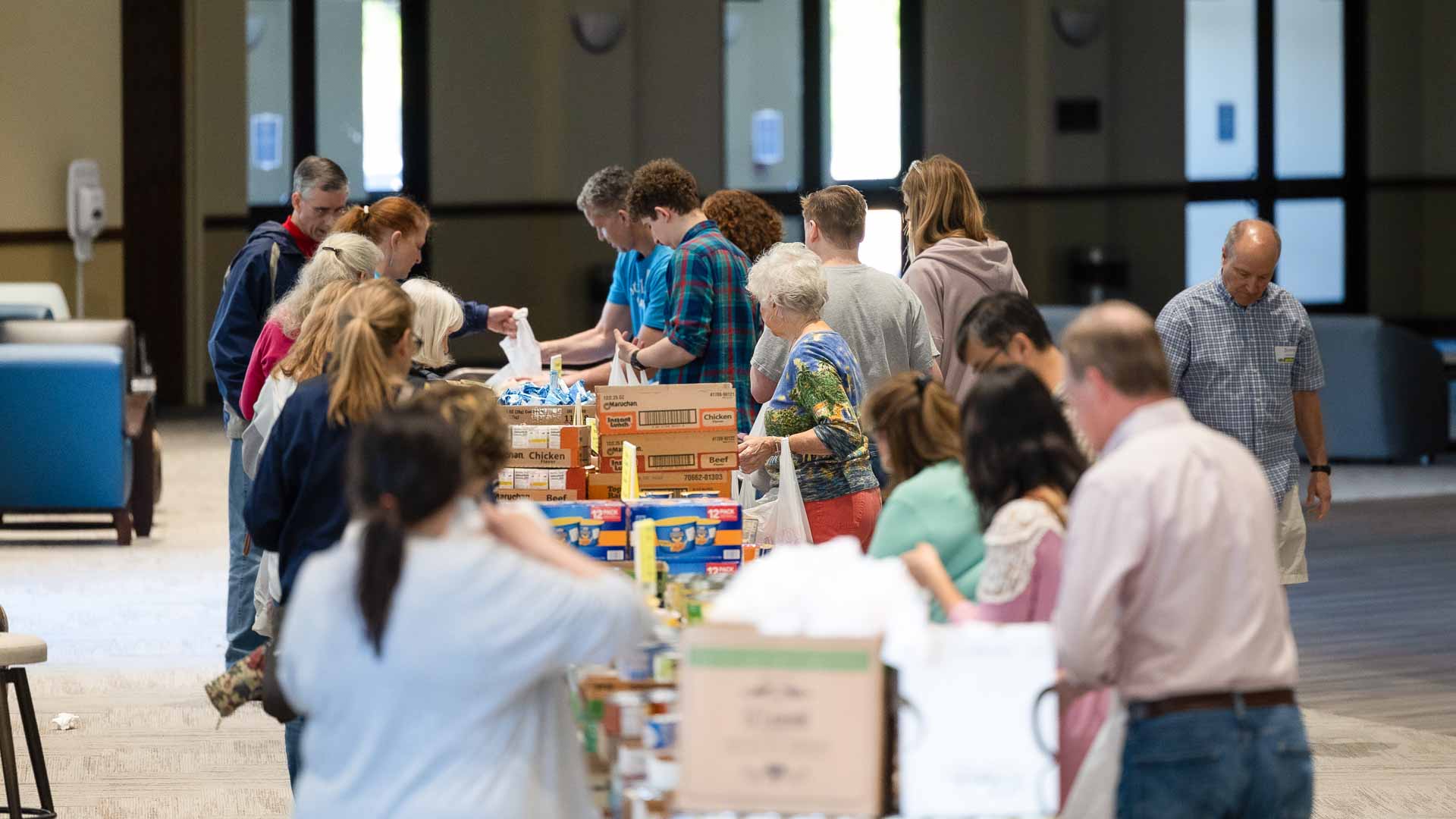 Go and Be volunteers packing donated food